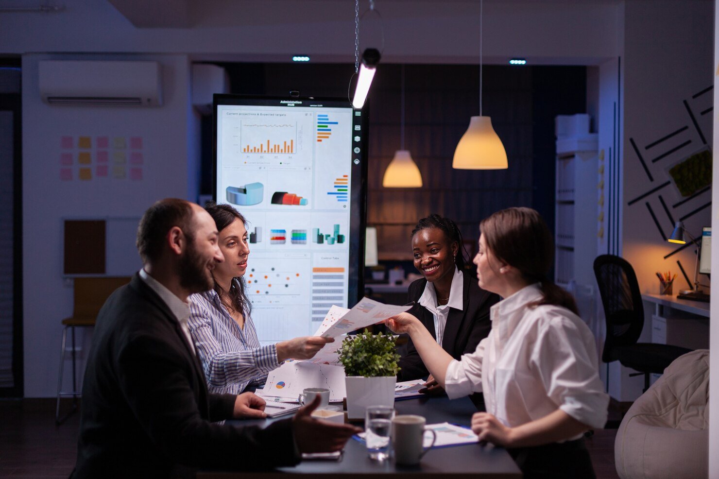 workaholics-businesspeople-brainstorming-financial-company-ideas-analyzing-strategy-paperwork-late-night-business-office-meeting-room_482257-2170